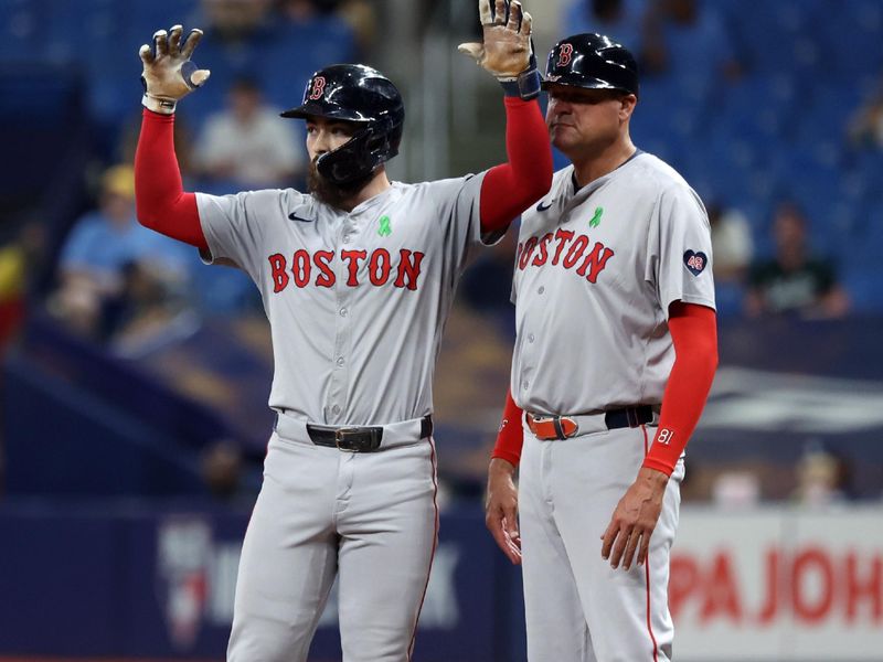 May 20, 2024; St. Petersburg, Florida, USA; Boston Red Sox catcher Connor Wong (12) celebrates to the dugout after he singles against the Tampa Bay Rays during the ninth inning  at Tropicana Field. Mandatory Credit: Kim Klement Neitzel-USA TODAY Sports