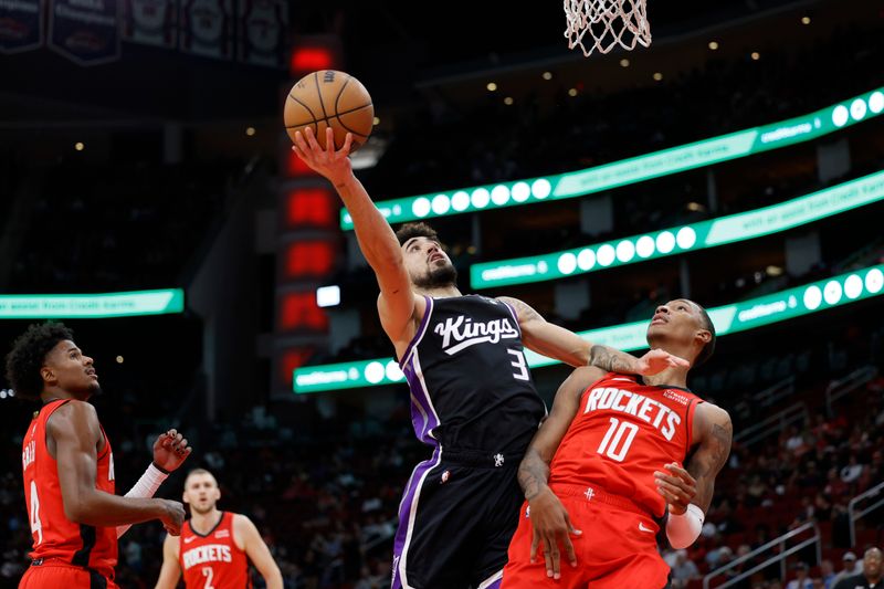 HOUSTON, TEXAS - NOVEMBER 06: Chris Duarte #3 of the Sacramento Kings drives to the basket over Jabari Smith Jr. #10 of the Houston Rockets during the first half at Toyota Center on November 06, 2023 in Houston, Texas. (Photo by Carmen Mandato/Getty Images)