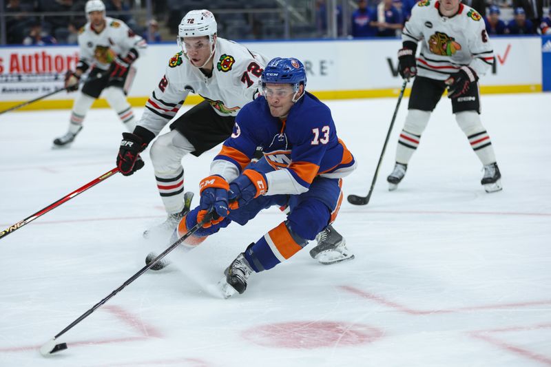 Apr 2, 2024; Elmont, New York, USA; New York Islanders center Mathew Barzal (13) skates with the puck against the Chicago Blackhawks during the second period at UBS Arena. Mandatory Credit: Thomas Salus-USA TODAY Sports