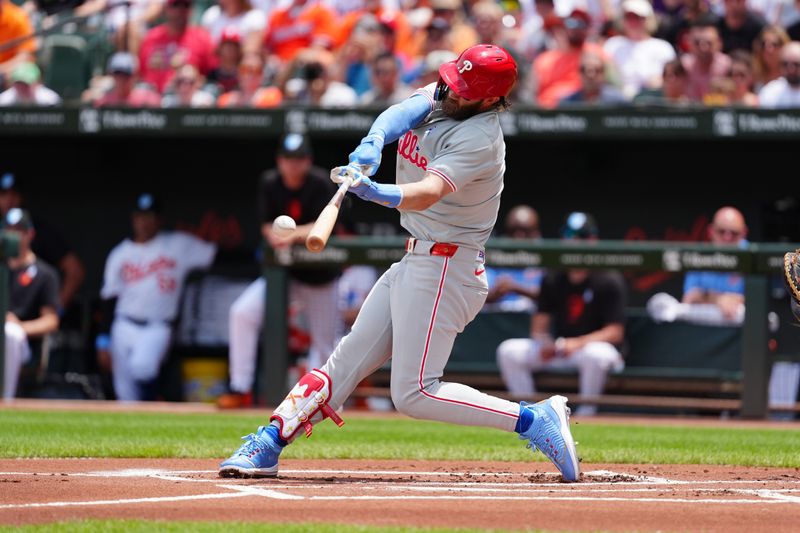 Jun 16, 2024; Baltimore, Maryland, USA; Philadelphia Phillies first baseman Bryce Harper (3) hits a single against the Baltimore Orioles during the first inning at Oriole Park at Camden Yards. Mandatory Credit: Gregory Fisher-USA TODAY Sports