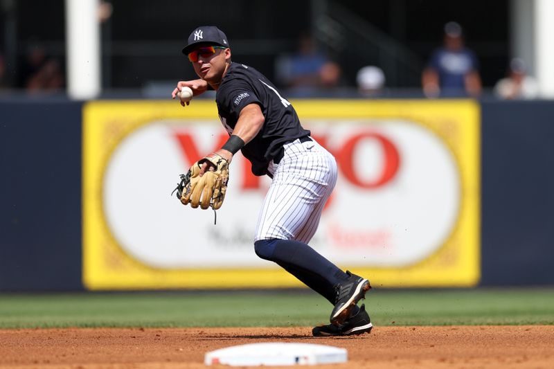 Mar 18, 2024; Tampa, Florida, USA;  New York Yankees shortstop Anthony Volpe (11) throws to first for an out against the Philadelphia Phillies in the second inning at George M. Steinbrenner Field. Mandatory Credit: Nathan Ray Seebeck-USA TODAY Sports