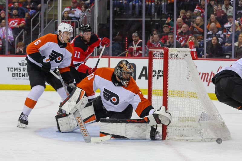 Jan 18, 2025; Newark, New Jersey, USA; Philadelphia Flyers goaltender Samuel Ersson (33) defends his net against the New Jersey Devils during the second period at Prudential Center. Mandatory Credit: Ed Mulholland-Imagn Images