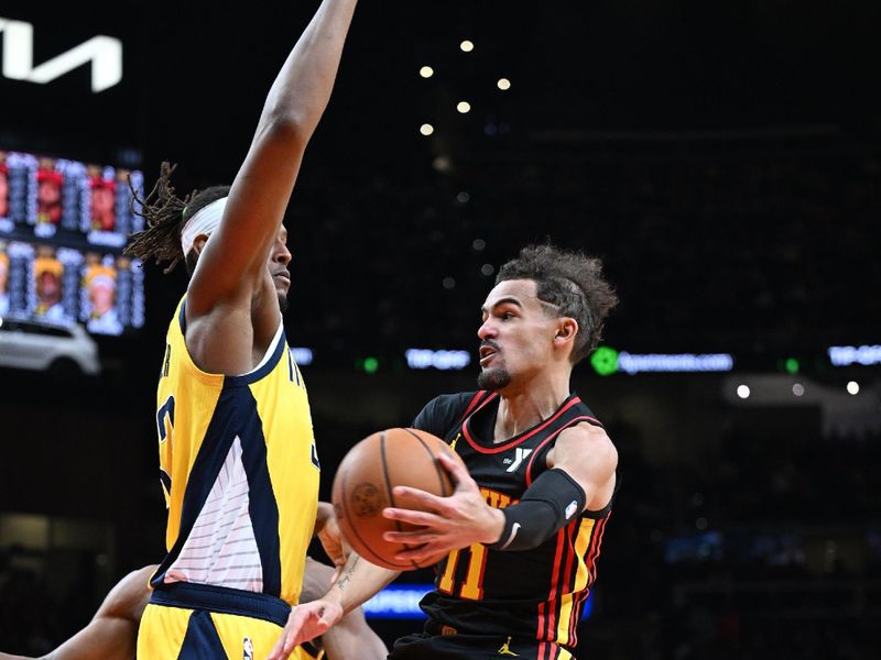 ATLANTA, GA - JANUARY 12: Trae Young #11 of the Atlanta Hawks passes the ball during the game against the Indiana Pacers on January 12, 2024 at State Farm Arena in Atlanta, Georgia.  NOTE TO USER: User expressly acknowledges and agrees that, by downloading and/or using this Photograph, user is consenting to the terms and conditions of the Getty Images License Agreement. Mandatory Copyright Notice: Copyright 2024 NBAE (Photo by Adam Hagy/NBAE via Getty Images)