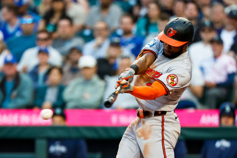 Jul 2, 2024; Seattle, Washington, USA; Baltimore Orioles center fielder Cedric Mullins (31) hits an RBI-single against the Seattle Mariners during the seventh inning at T-Mobile Park. Mandatory Credit: Joe Nicholson-USA TODAY Sports