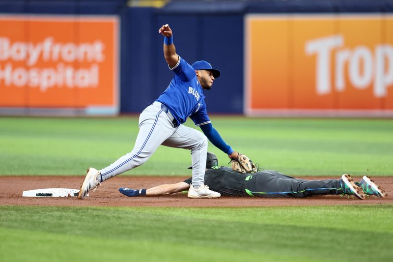 Sep 21, 2024; St. Petersburg, Florida, USA; Tampa Bay Rays second baseman Brandon Lowe (8) is caught stealing by Toronto Blue Jays shortstop Leo Jimenez (49) in the first inning at Tropicana Field. Mandatory Credit: Nathan Ray Seebeck-Imagn Images