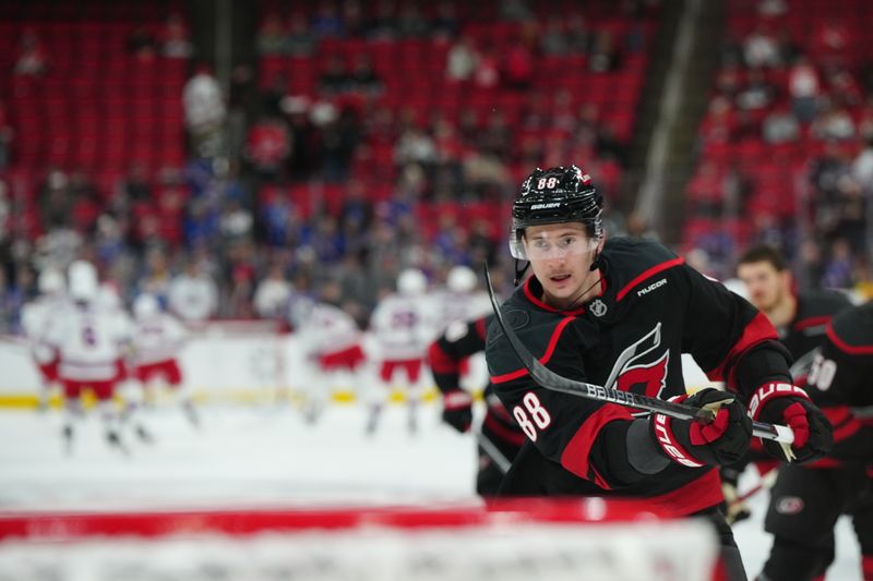 Nov 27, 2024; Raleigh, North Carolina, USA;  Carolina Hurricanes center Martin Necas (88) takes a shot during the warmups before the game against the New York Rangers at Lenovo Center. Mandatory Credit: James Guillory-Imagn Images