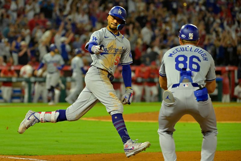 Sep 3, 2024; Anaheim, California, USA;  Los Angeles Dodgers shortstop Mookie Betts (50) celebrates as he rounds the bases after hitting a three-run home run in the tenth inning against the Los Angeles Angels at Angel Stadium. Mandatory Credit: Jayne Kamin-Oncea-Imagn Images