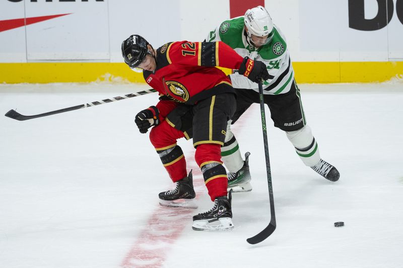 Nov 11, 2025; Ottawa, Ontario, CAN; Ottawa Senators center Shane Pinto (12) battles with Dallas Stars center Tyler Seguin (91) in overtime at the Canadian Tire Centre. Mandatory Credit: Marc DesRosiers-IMAGN Images