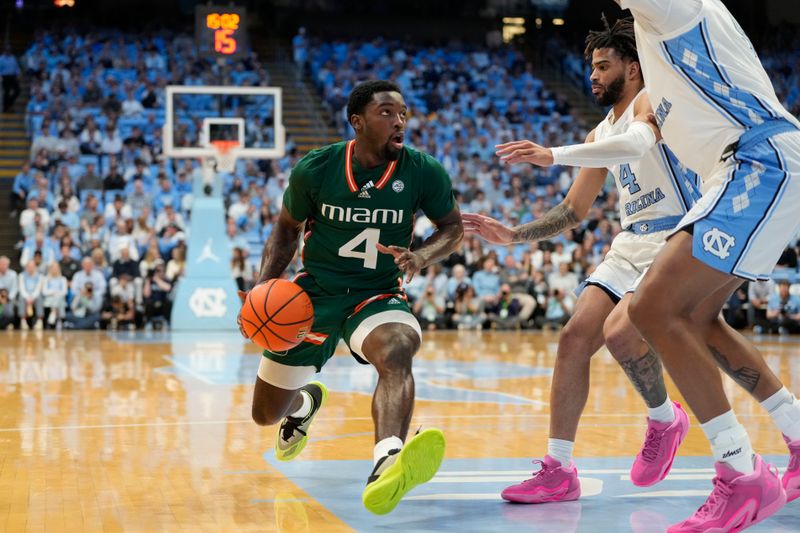 Feb 26, 2024; Chapel Hill, North Carolina, USA; Miami (Fl) Hurricanes guard Bensley Joseph (4) with the ball as North Carolina Tar Heels guard RJ Davis (4) defends in the first half at Dean E. Smith Center. Mandatory Credit: Bob Donnan-USA TODAY Sports