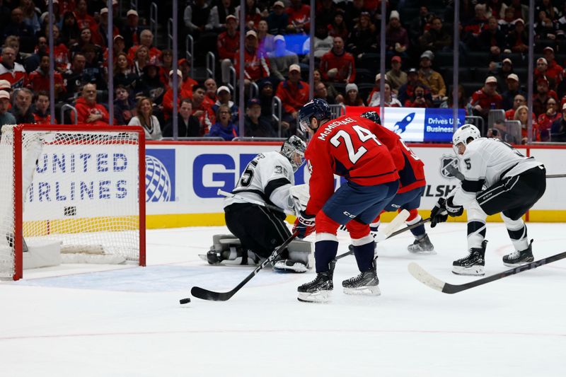 Nov 17, 2025; Washington, District of Columbia, USA; Washington Capitals center Connor McMichael (24) attempts a shot on Los Angeles Kings goaltender Darcy Kuemper (35) during the first period at Capital One Arena. Mandatory Credit: Geoff Burke-Imagn Images