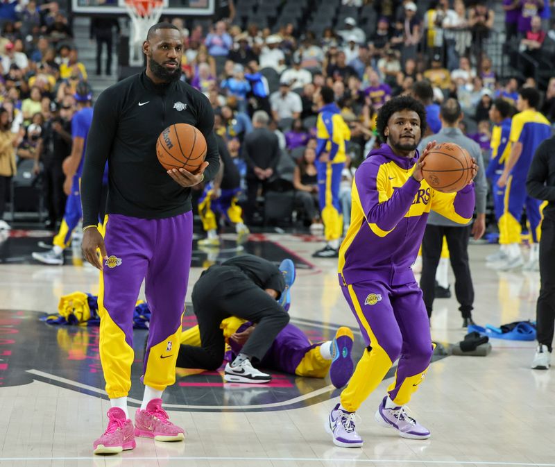 LAS VEGAS, NEVADA - OCTOBER 15: LeBron James (L) #23 and Bronny James #9 of the Los Angeles Lakers warm up before a preseason game against the Golden State Warriors at T-Mobile Arena at T-Mobile Arena on October 15, 2024 in Las Vegas, Nevada. The Warriors defeated the Lakers 111-97. NOTE TO USER: User expressly acknowledges and agrees that, by downloading and or using this photograph, User is consenting to the terms and conditions of the Getty Images License Agreement. (Photo by Ethan Miller/Getty Images)