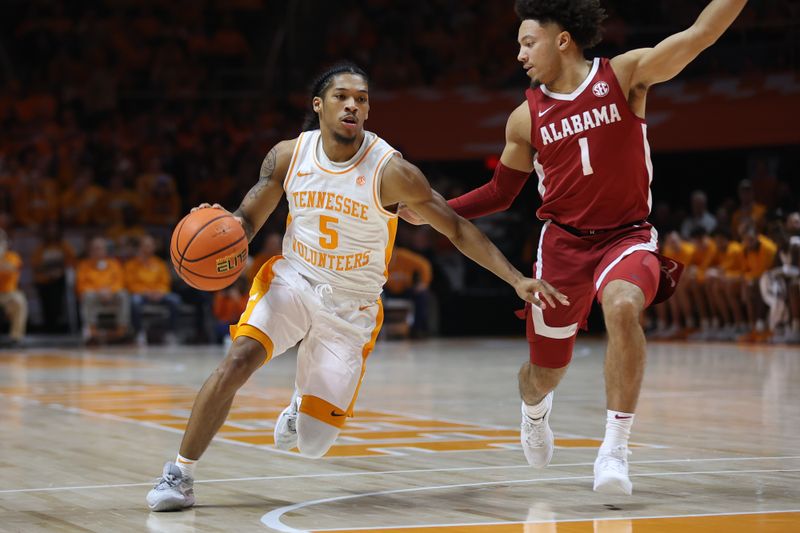 Jan 20, 2024; Knoxville, Tennessee, USA; Tennessee Volunteers guard Zakai Zeigler (5) moves the ball against Alabama Crimson Tide guard Mark Sears (1) during the first half at Thompson-Boling Arena at Food City Center. Mandatory Credit: Randy Sartin-USA TODAY Sports