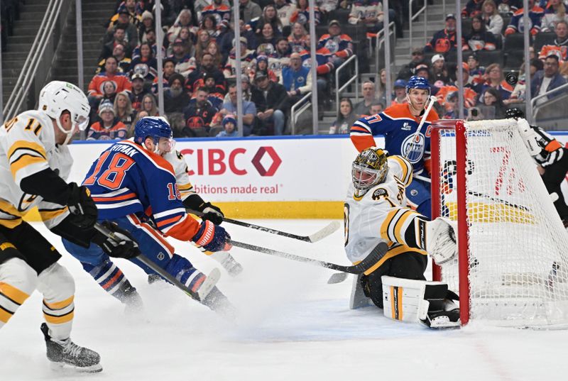 Dec 31, 2025; Edmonton, Alberta, CAN;  Edmonton Oilers left winger Zach Hyman (18) shoots on Boston Bruins goalie Jeremy Swayman (1) during the first period at Rogers Place. Mandatory Credit: Walter Tychnowicz-Imagn Images