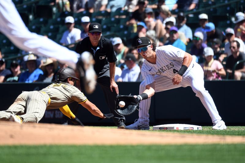 Aug 18, 2024; Denver, Colorado, USA; Colorado Rockies first baseman Michael Toglia (4) catches the ball on a pickoff play against San Diego Padres shortstop Ha-Seong Kim (7) in the third inning at Coors Field. Mandatory Credit: Christopher Hanewinckel-USA TODAY Sports
