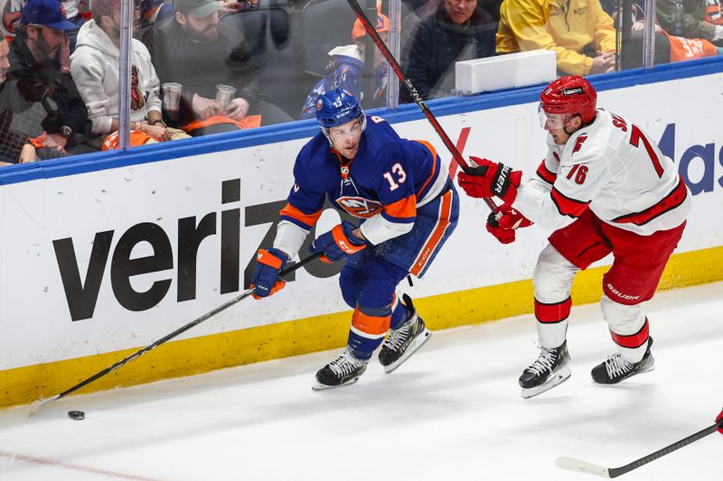 Apr 27, 2024; Elmont, New York, USA; New York Islanders center Mathew Barzal (13) and Carolina Hurricanes defenseman Brady Skjei (76) battle for control of the puck in the first period in game four of the first round of the 2024 Stanley Cup Playoffs at UBS Arena. Mandatory Credit: Wendell Cruz-USA TODAY Sports