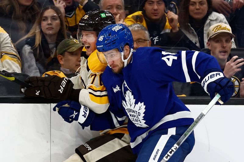 Mar 7, 2024; Boston, Massachusetts, USA; Toronto Maple Leafs defenseman Ilya Lyubushkin (46) checks Boston Bruins goaltender Brandon Bussi (70) into the boards during the third period at TD Garden. Mandatory Credit: Winslow Townson-USA TODAY Sports