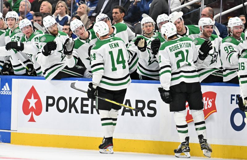 Feb 7, 2024; Toronto, Ontario, CAN; Dallas Stars forward Jamie Benn (14) celebrates with team mates at the bench after scoring against the Toronto Maple Leafs in the first period at Scotiabank Arena. Mandatory Credit: Dan Hamilton-USA TODAY Sports