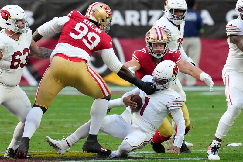 Arizona Cardinals quarterback Kyler Murray (1) is sacked against San Francisco 49ers defensive tackle Javon Kinlaw (99) and defensive end Nick Bosa (97) during the first half of an NFL football game Sunday, Dec. 17, 2023, in Glendale, Ariz. (AP Photo/Ross D. Franklin)