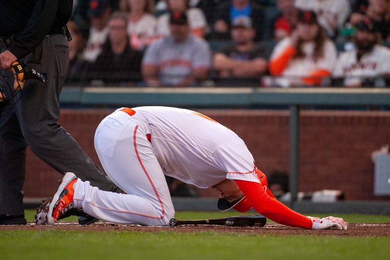 Sep 12, 2023; San Francisco, California, USA; San Francisco Giants first baseman Wilmer Flores (41) is brought to his knees after hitting a ball off his leg during the third inning at Oracle Park. Mandatory Credit: Ed Szczepanski-USA TODAY Sports