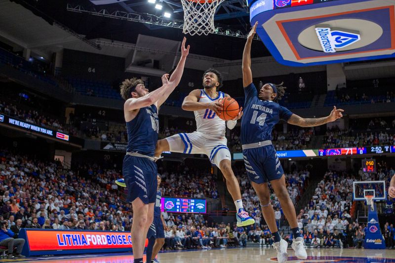 Jan 17, 2023; Boise, Idaho, USA; Boise State Broncos guard Marcus Shaver Jr. (10) splits the defense of Nevada Wolf Pack center Will Baker (50) and forward Tre Coleman (14) during the second half at ExtraMile Arena. Boise State defeats Nevada 77-62. Mandatory Credit: Brian Losness-USA TODAY Sports

