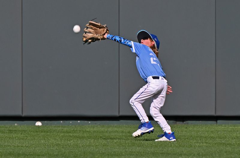 Sep 19, 2023; Kansas City, Missouri, USA; Bode Greinke, the son of Kansas City Royals pitcher Zack Greinke (not pictured) attempts to catch a fly ball during batting practice before a game against the Cleveland Guardians at Kauffman Stadium. Mandatory Credit: Peter Aiken-USA TODAY Sports