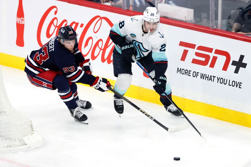 Oct 23, 2025; Winnipeg, Manitoba, CAN; Seattle Kraken defenseman Joshua Mahura (28) is checked by Winnipeg Jets center Brad Lambert (93) in the second period at Canada Life Centre. Mandatory Credit: James Carey Lauder-Imagn Images