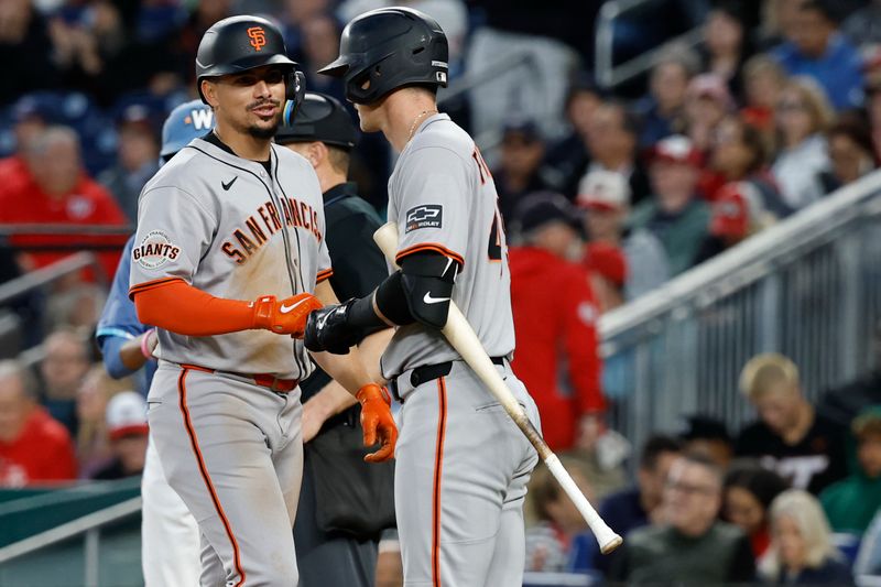 May 23, 2025; Washington, District of Columbia, USA; San Francisco Giants shortstop Willy Adames (2) celebrates with Giants second base Tyler Fitzgerald (49) after scoring a run on a bases loaded walk against the Washington Nationals during the seventh inning at Nationals Park. Mandatory Credit: Geoff Burke-Imagn Images
