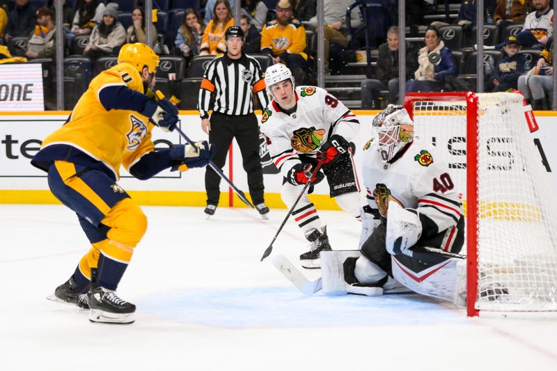 Jan 16, 2025; Nashville, Tennessee, USA;  Chicago Blackhawks goaltender Arvid Soderblom (40) blocks the shot of Nashville Predators center Colton Sissons (10) during the third period at Bridgestone Arena. Mandatory Credit: Steve Roberts-Imagn Images