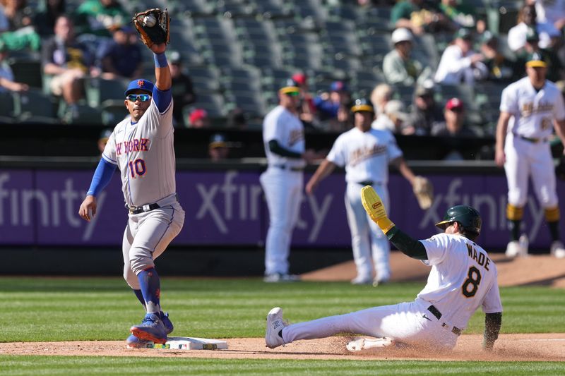 Apr 16, 2023; Oakland, California, USA; New York Mets third baseman Eduardo Escobar (10) catches a throw to force out Oakland Athletics pinch hitter Tyler Wade (8) during the tenth inning at RingCentral Coliseum. Mandatory Credit: Darren Yamashita-USA TODAY Sports