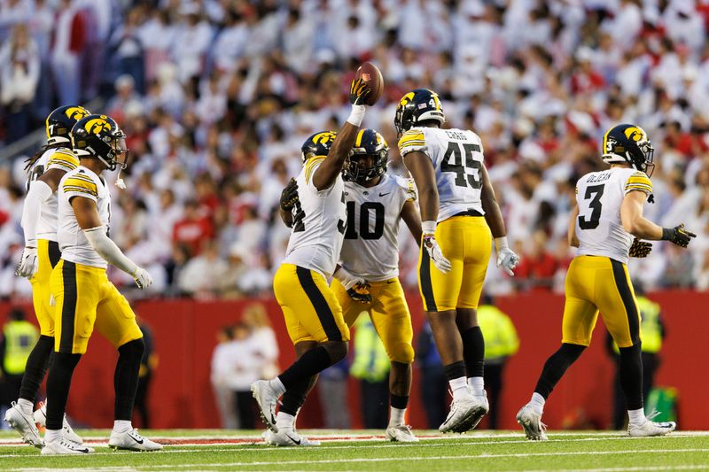 Oct 14, 2023; Madison, Wisconsin, USA;  The Iowa Hawkeyes defense celebrates after recovering a fumble during the fourth quarter against the Wisconsin Badgers at Camp Randall Stadium. Mandatory Credit: Jeff Hanisch-USA TODAY Sports