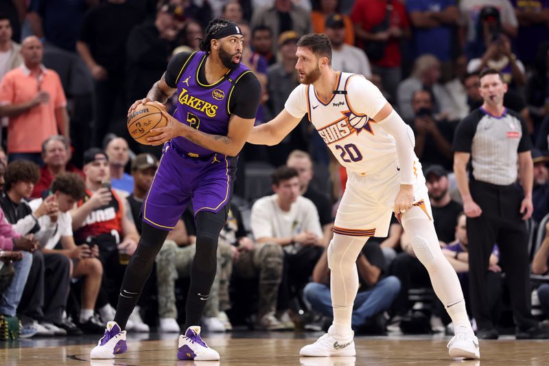 PHOENIX, ARIZONA - OCTOBER 28: Anthony Davis #3 of the Los Angeles Lakers makes a move on Jusuf Nurkic #20 of the Phoenix Suns during the first half at Footprint Center on October 28, 2024 in Phoenix, Arizona. NOTE TO USER: User expressly acknowledges and agrees that, by downloading and or using this photograph, User is consenting to the terms and conditions of the Getty Images License Agreement. (Photo by Christian Petersen/Getty Images)