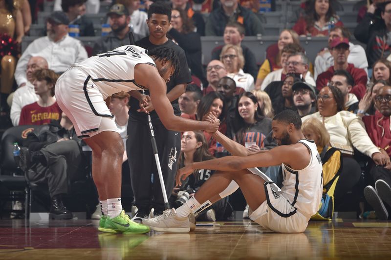 CLEVELAND, OH - MARCH 10: Cam Thomas #24 helps up Mikal Bridges #1 of the Brooklyn Nets during the game against the Cleveland Cavaliers on March 10, 2024 at Rocket Mortgage FieldHouse in Cleveland, Ohio. NOTE TO USER: User expressly acknowledges and agrees that, by downloading and/or using this Photograph, user is consenting to the terms and conditions of the Getty Images License Agreement. Mandatory Copyright Notice: Copyright 2024 NBAE (Photo by David Liam Kyle/NBAE via Getty Images)