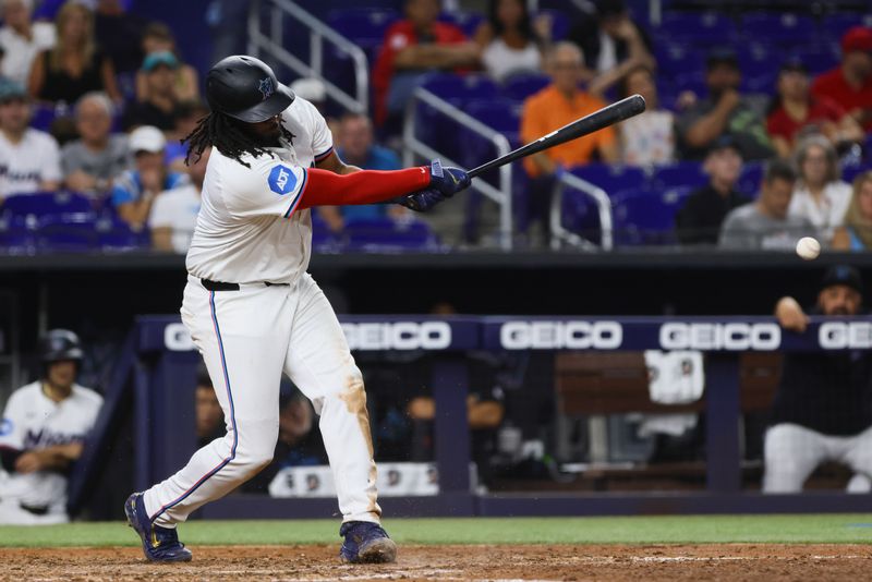 Jun 5, 2024; Miami, Florida, USA; Miami Marlins first baseman Josh Bell (9) hits a single against the Tampa Bay Rays during the eighth inning at loanDepot Park. Mandatory Credit: Sam Navarro-USA TODAY Sports