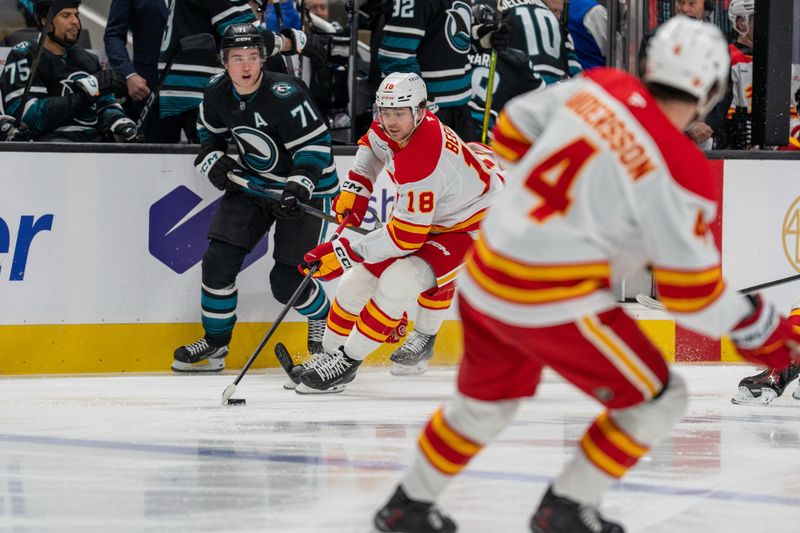 Dec 16, 2025; San Jose, California, USA; Calgary Flames center John Beecher (18) controls the puck against San Jose Sharks center Macklin Celebrini (71) during the second period at SAP Center at San Jose. Mandatory Credit: Neville E. Guard-Imagn Images