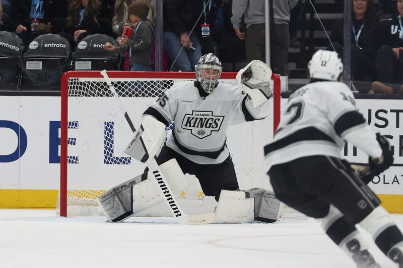 Apr 3, 2025; Salt Lake City, Utah, USA; Los Angeles Kings goaltender Darcy Kuemper (35) makes a glove save against the Utah Hockey Club during the first period at Delta Center. Mandatory Credit: Rob Gray-Imagn Images