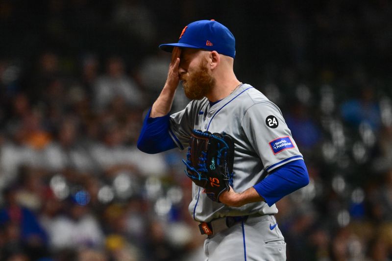 Sep 28, 2024; Milwaukee, Wisconsin, USA; New York Mets pitcher Reed Garrett (75) reacts after giving up a run in the eighth inning against the Milwaukee Brewers at American Family Field. Mandatory Credit: Benny Sieu-Imagn Images