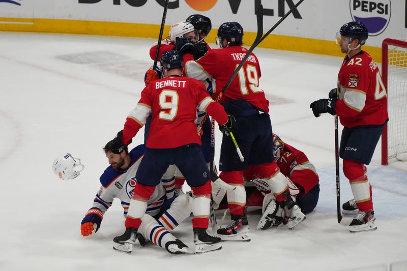 Jun 8, 2024; Sunrise, Florida, USA;  a fight breaks out after Edmonton Oilers forward Zach Hyman (18) is checked into Florida Panthers goaltender Sergei Bobrovsky (72) by forward Sam Bennett (9) during the first period in game one of the 2024 Stanley Cup Final at Amerant Bank Arena. Mandatory Credit: Jim Rassol-USA TODAY Sports