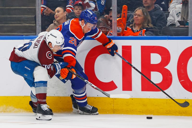 Apr 13, 2026; Edmonton, Alberta, CAN; Edmonton Oilers forward Curtis Lazar (20) and Colorado Avalanche defensemen Sam Mlinski (70) battle along the boards for a loose puck  during the third period at Rogers Place. Mandatory Credit: Perry Nelson-Imagn Images