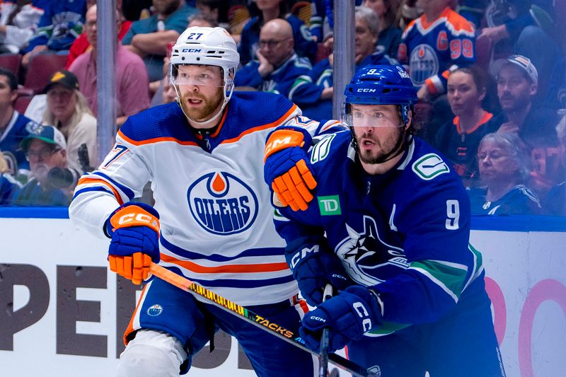 May 16, 2024; Vancouver, British Columbia, CAN; Edmonton Oilers defenseman Brett Kulak (27) battles with Vancouver Canucks forward J.T. Miller (9) during the third period in game five of the second round of the 2024 Stanley Cup Playoffs at Rogers Arena. Mandatory Credit: Bob Frid-USA TODAY Sports