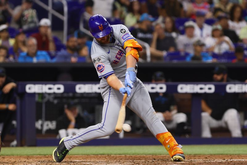 Jul 21, 2024; Miami, Florida, USA; New York Mets first baseman Pete Alonso (20) hits a single against the Miami Marlins during the fourth inning at loanDepot Park. Mandatory Credit: Sam Navarro-USA TODAY Sports