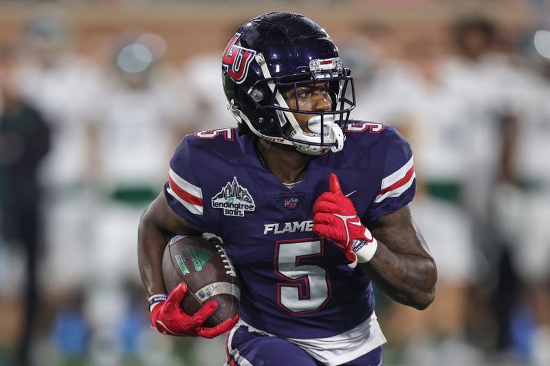 Dec 18, 2021; Mobile, Alabama, USA; Liberty Flames wide receiver DJ Stubbs (5) runs the ball against the Eastern Michigan Eagles in the fourth quarter of the 2021 LendingTree Bowl , toppicat Hancock Whitney Stadium. Mandatory Credit: Robert McDuffie-USA TODAY Sports