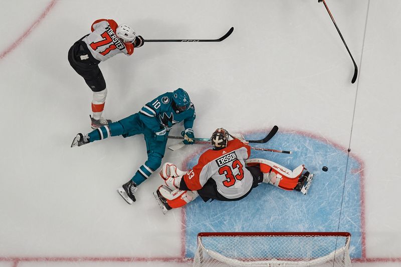 Nov 7, 2023; San Jose, California, USA; San Jose Sharks left wing Anthony Duclair (10) shoots the puck against Philadelphia Flyers goaltender Samuel Ersson (33) and right wing Tyson Foerster (71) during the first period at SAP Center at San Jose. Mandatory Credit: Robert Edwards-USA TODAY Sports