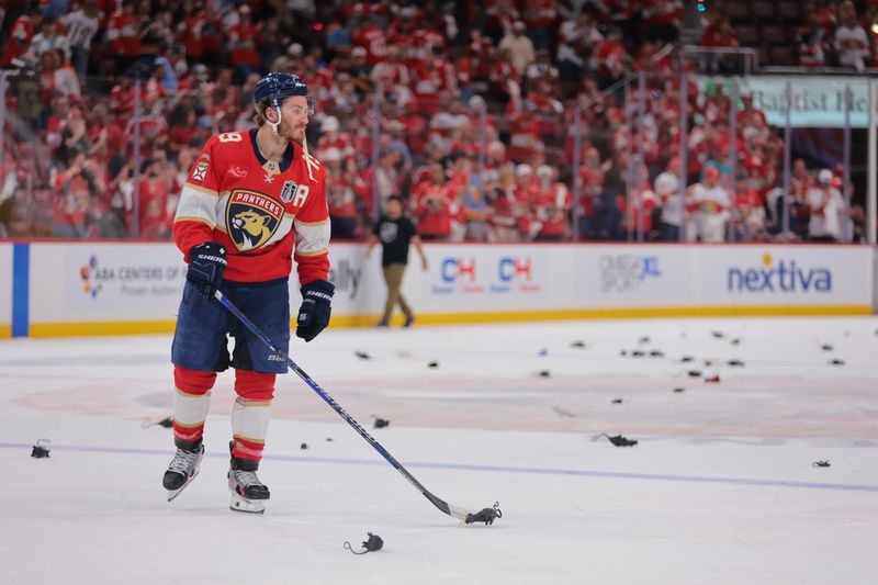 Jun 9, 2025; Sunrise, Florida, USA; Florida Panthers forward Matthew Tkachuk (19) puts a rat on the stick after the third period against the Edmonton Oilers in game three of the 2025 Stanley Cup Final at Amerant Bank Arena. Mandatory Credit: Sam Navarro-Imagn Images