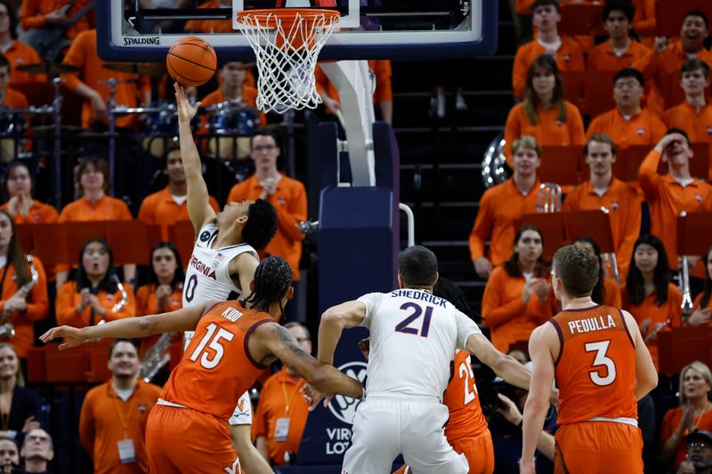 Jan 18, 2023; Charlottesville, Virginia, USA; Virginia Cavaliers guard Kihei Clark (0) shoots the ball as Virginia Tech Hokies center Lynn Kidd (15) defends in the first half at John Paul Jones Arena. Mandatory Credit: Geoff Burke-USA TODAY Sports