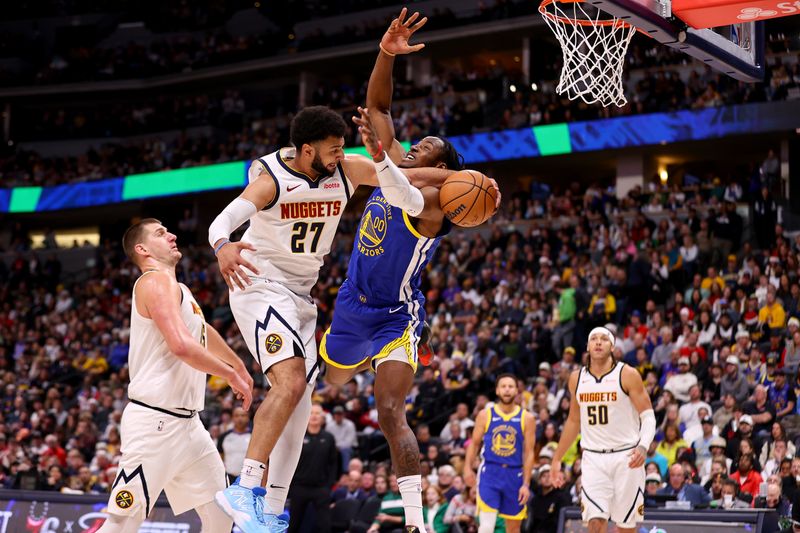 DENVER, COLORADO - DECEMBER 25: Jamal Murray #27 of the Denver Nuggets defends Jonathan Kuminga #00 of the Golden State Warriors at Ball Arena on December 25, 2023 in Denver, Colorado. NOTE TO USER: User expressly acknowledges and agrees that, by downloading and/or using this Photograph, user is consenting to the terms and conditions of the Getty Images License Agreement. (Photo by Jamie Schwaberow/Getty Images)