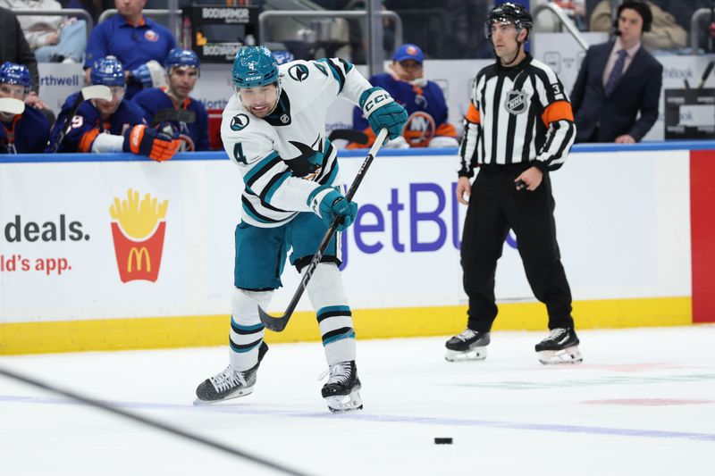 Jan 18, 2025; Elmont, New York, USA;  San Jose Sharks defenseman Cody Ceci (4) makes a pass against the New York Islanders during the third period at UBS Arena. Mandatory Credit: Thomas Salus-Imagn Images