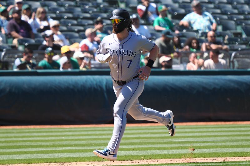 May 23, 2024; Oakland, California, USA; Colorado Rockies pinch runner Brendan Rodgers (7) scores a run against the Oakland Athletics during the tenth inning at Oakland-Alameda County Coliseum. Mandatory Credit: Kelley L Cox-USA TODAY Sports