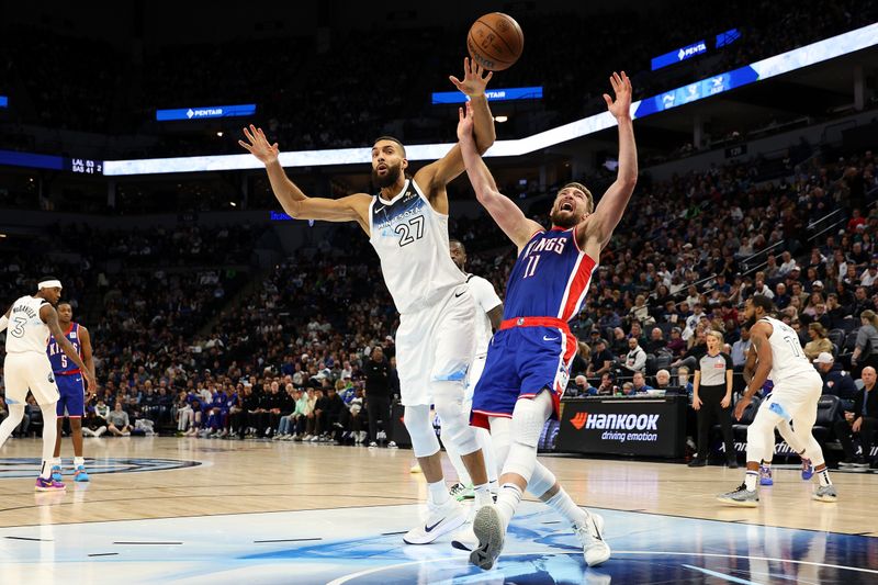 MINNEAPOLIS, MINNESOTA - NOVEMBER 27: Rudy Gobert #27 of the Minnesota Timberwolves fouls Domantas Sabonis #11 of the Sacramento Kings in the third quarter at Target Center on November 27, 2024 in Minneapolis, Minnesota. The Kings defeated the Timberwolves 115-104. NOTE TO USER: User expressly acknowledges and agrees that, by downloading and or using this photograph, User is consenting to the terms and conditions of the Getty Images License Agreement. (Photo by David Berding/Getty Images)