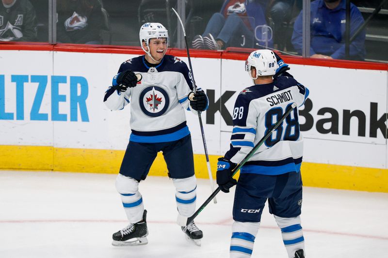 Oct 19, 2022; Denver, Colorado, USA; Winnipeg Jets center Cole Perfetti (91) celebrates his goal with defenseman Nate Schmidt (88) in the second period against the Colorado Avalanche at Ball Arena. Mandatory Credit: Isaiah J. Downing-USA TODAY Sports