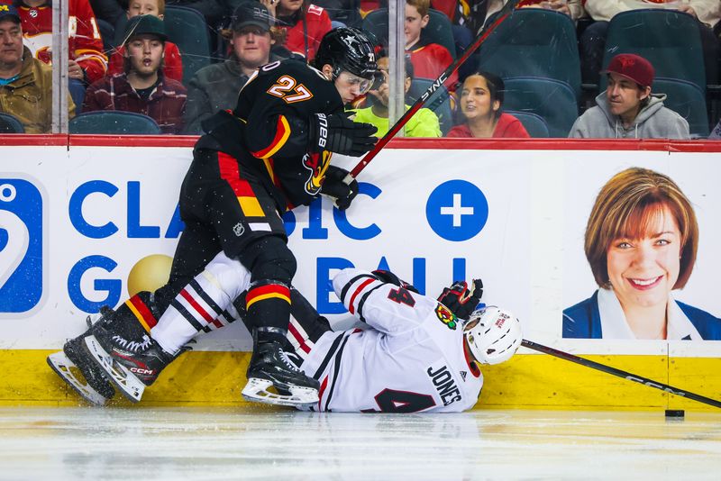 Jan 27, 2024; Calgary, Alberta, CAN; Calgary Flames right wing Matt Coronato (27) and Chicago Blackhawks defenseman Seth Jones (4) battles for the puck during the second period at Scotiabank Saddledome. Mandatory Credit: Sergei Belski-USA TODAY Sports